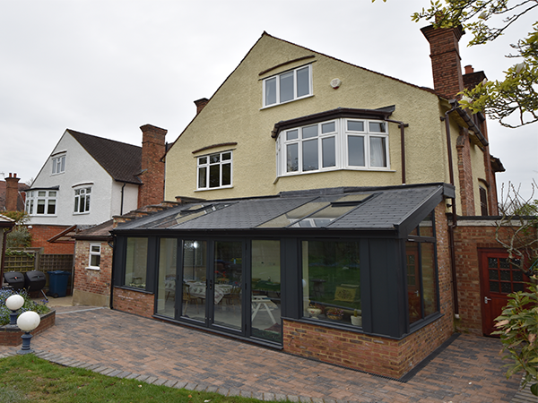 An Anthracite Grey Solid Roof Conservatory With French Doors