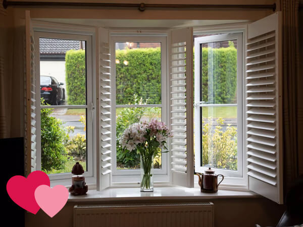 The inside of a white flush UPVC window with shutters